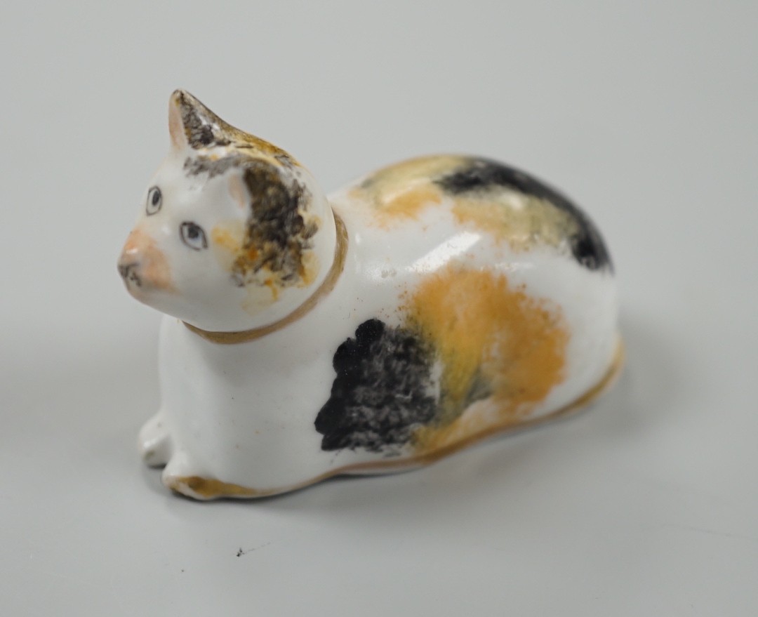 A rare small Staffordshire porcelain figure of a recumbent cat, c.1830-50. 6cm long, Cf. Dennis G.Rice Cats in English porcelain, colour plate 54., Provenance: Dennis G.Rice collection